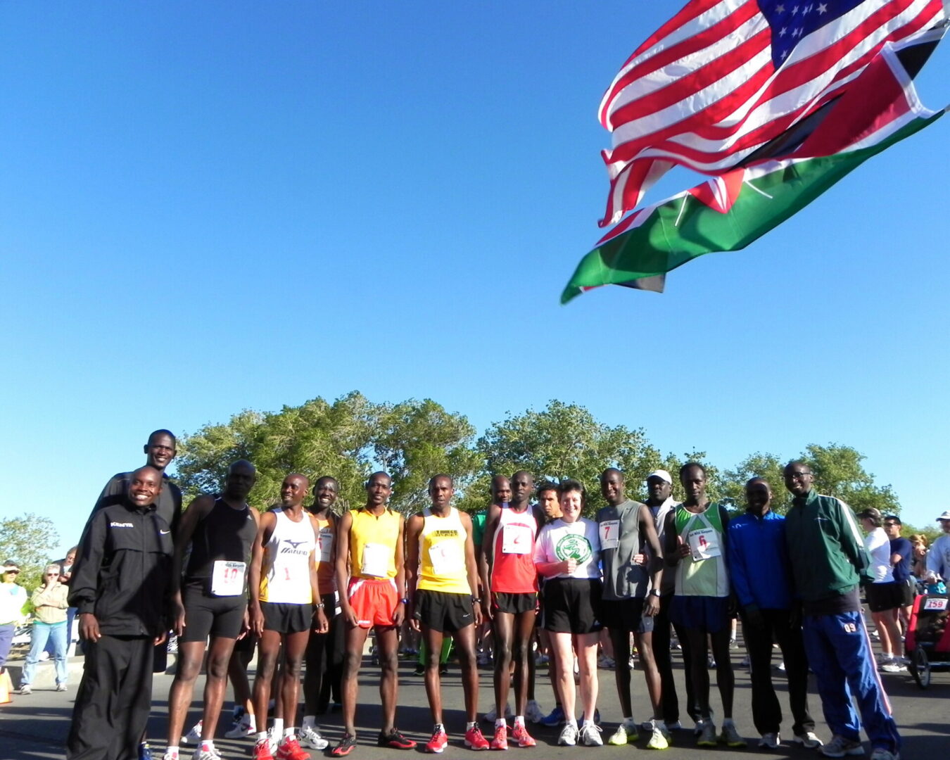 Runners posing with flags at race start
