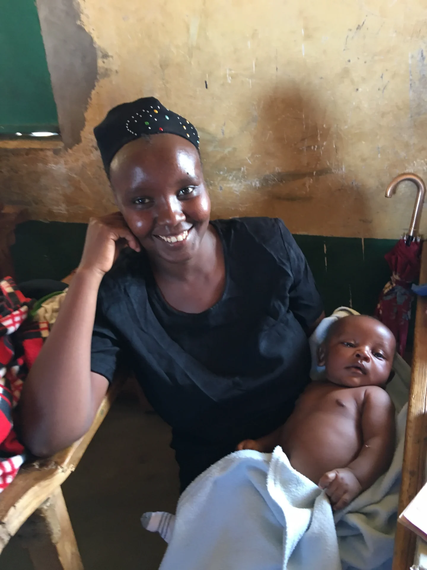 Smiling woman holding a baby