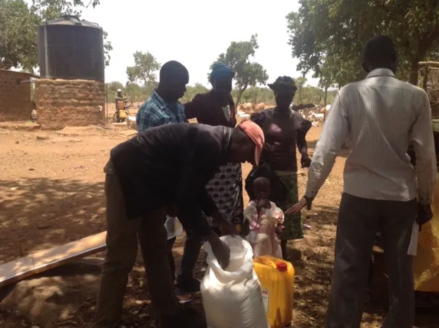 People distributing supplies in rural area