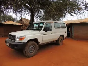 Off-road vehicle near rural huts