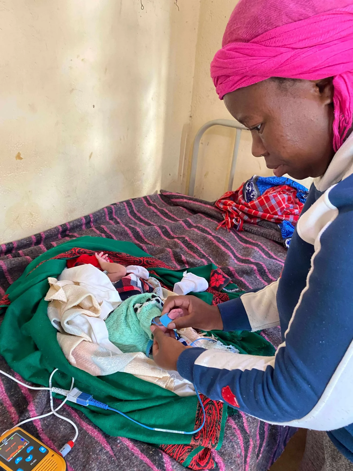 Woman checking baby’s health with device