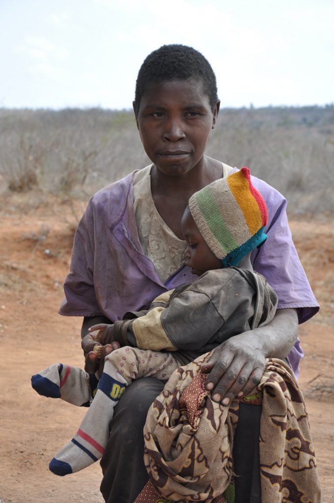 Woman with baby on dusty path