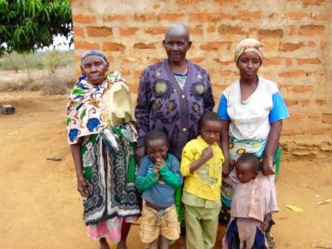 Family standing together near a brick wall