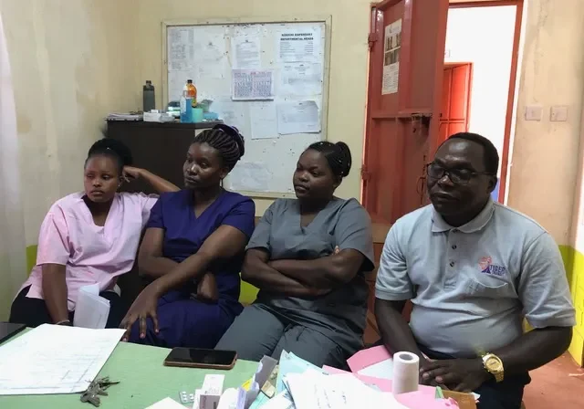 Healthcare team gathered in a clinic room